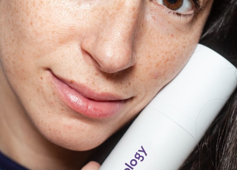 woman holding Curology bottle